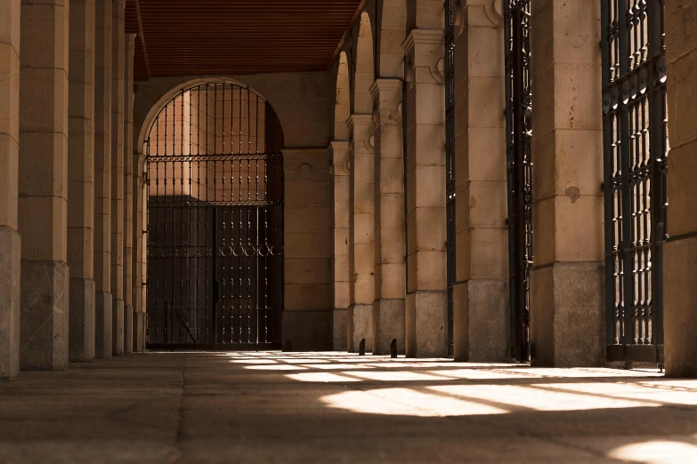 a stone building has arched doorways with intricate iron design