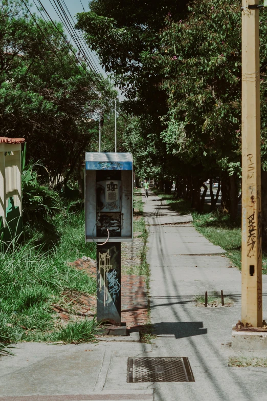 an old pay phone on a city street