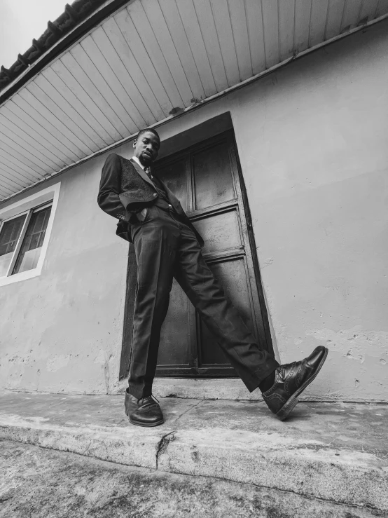 a man stands outside a building next to an open door