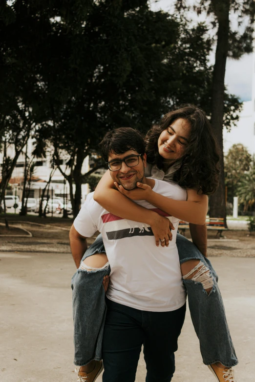 two people standing outside holding each other