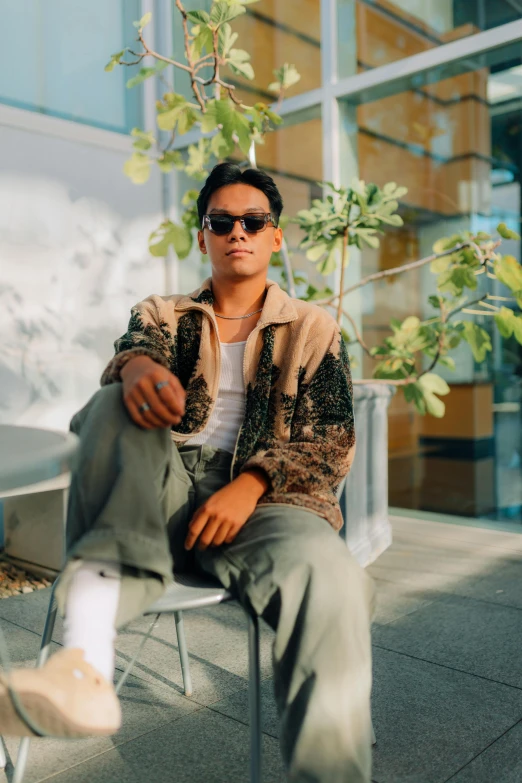 a man sits on a metal chair in the city