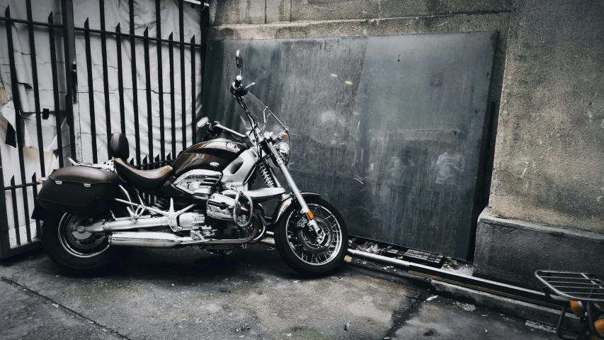 a motorbike sitting in front of an industrial gate