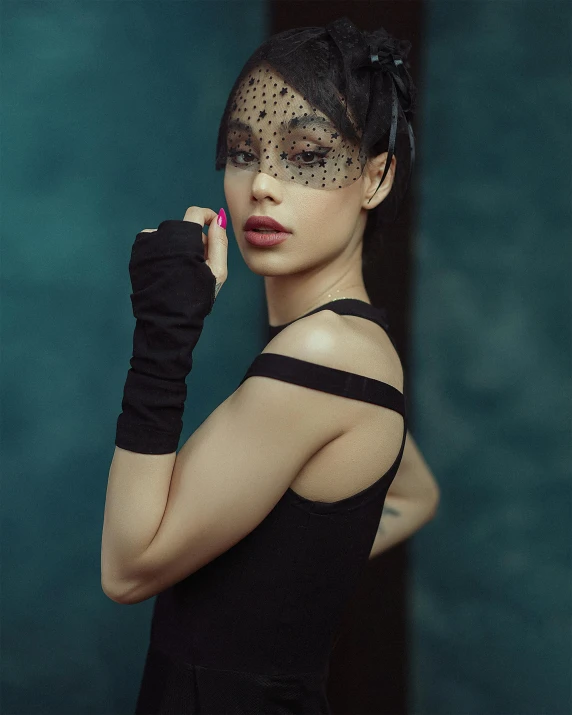 a woman with gold and black make - up poses for the camera