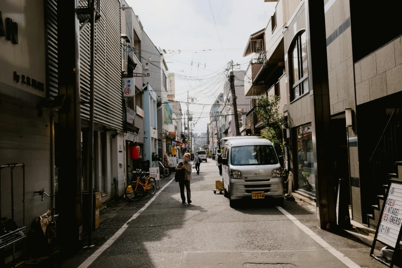 an empty street with small cars and buildings