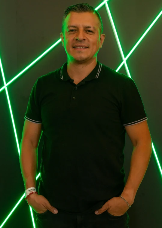 a man standing in front of neon colored lines