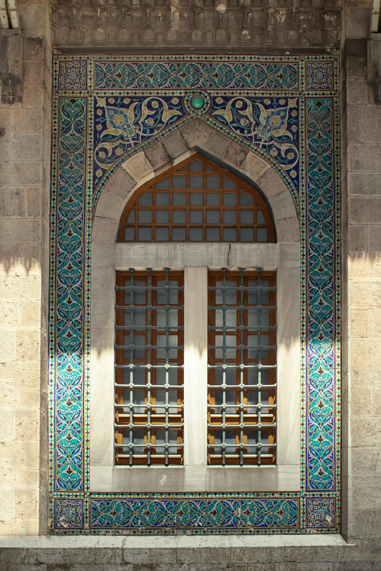 a bench is in front of an arched window