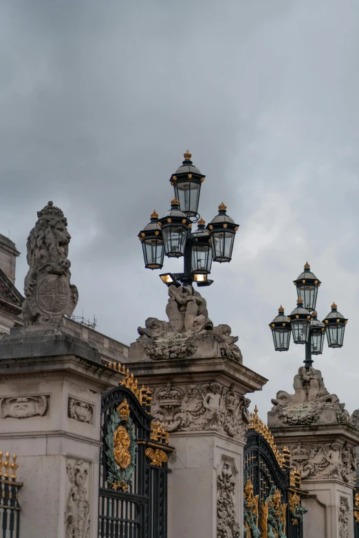 the lamps on the building have ornately carved designs