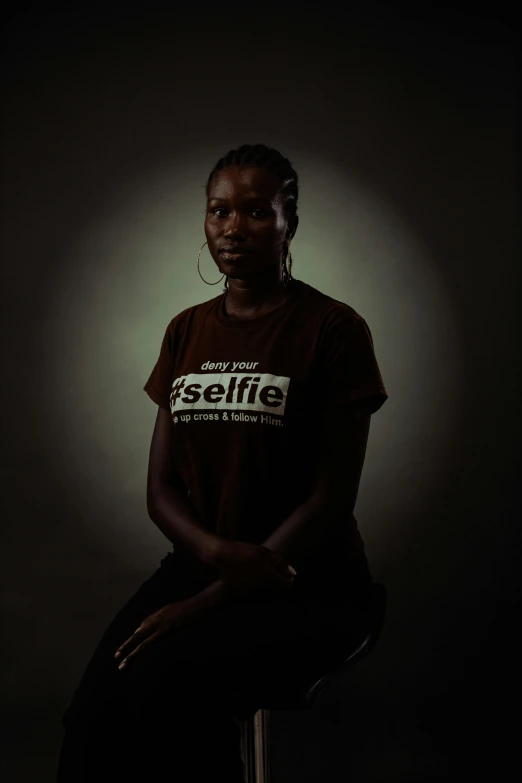 an african american woman sits in a chair