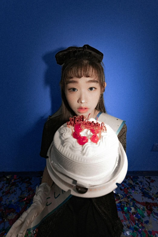 a  holding a cake over her face