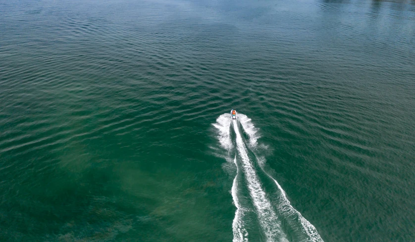 a boat is riding across a body of water