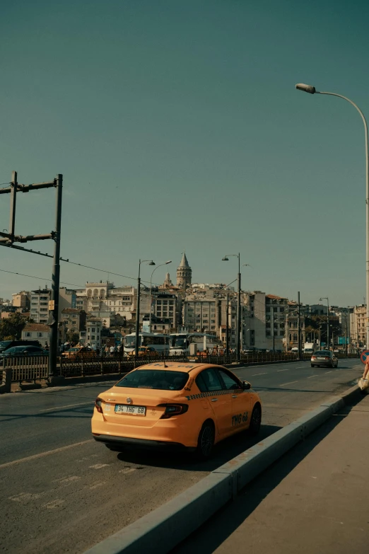 an orange car sitting at a traffic light