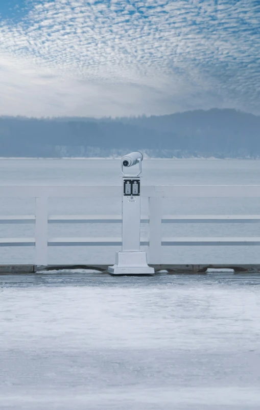 there is a tall white pole on the dock