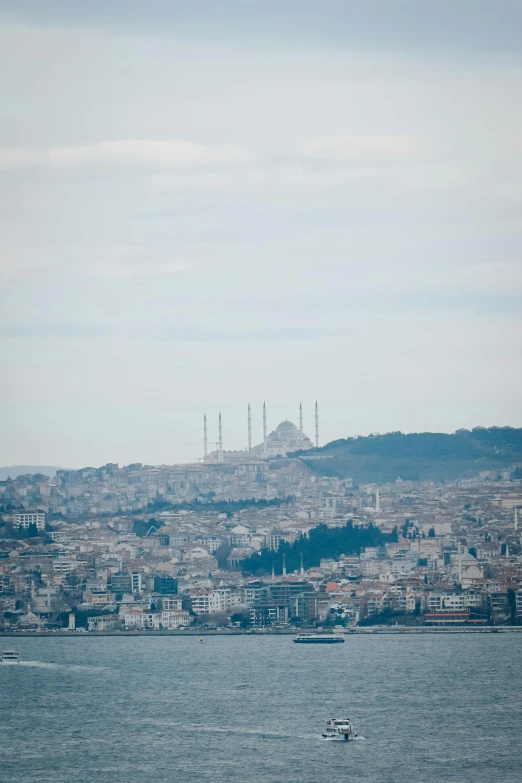 a boat is sailing in front of a city