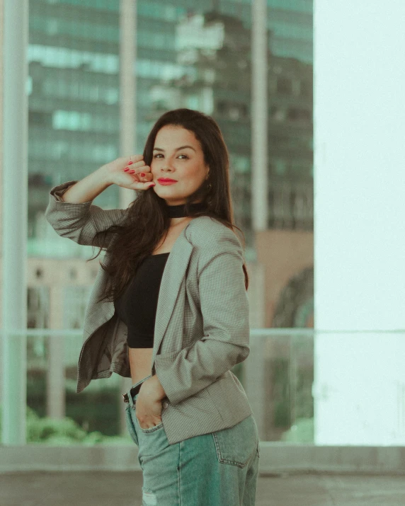 a woman is standing in front of a tall building