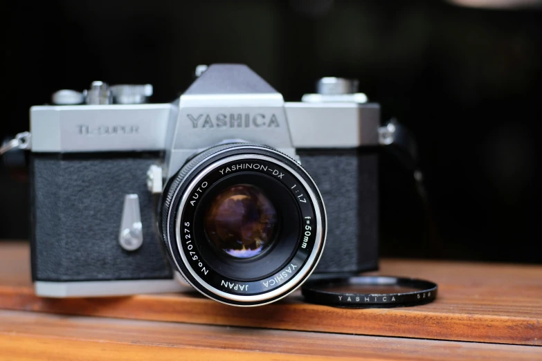 an old, vintage yashika camera with a flash drive attached