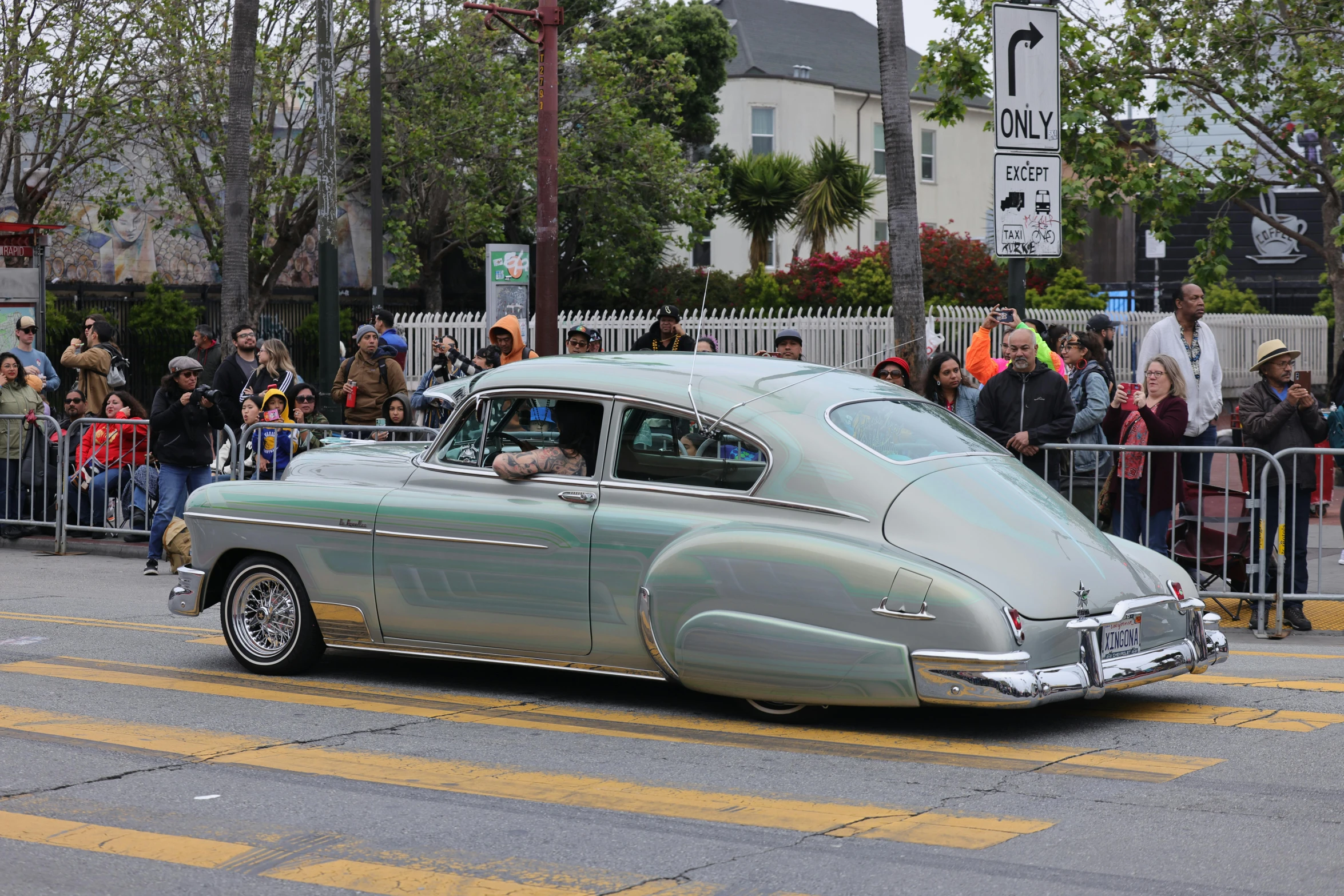 an antique car with a large windshield on the road