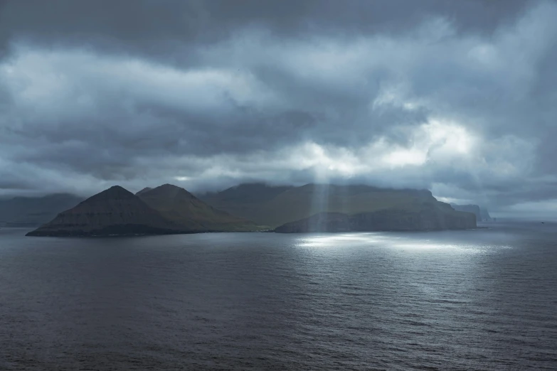 a lake surrounded by hills on the water