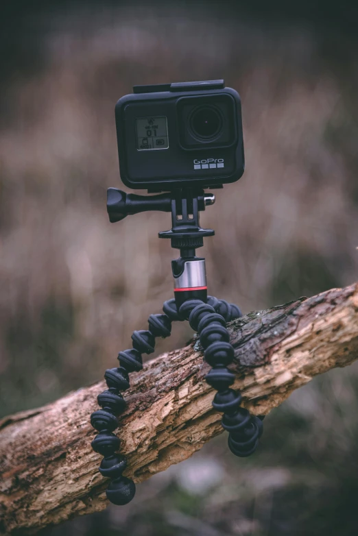 a camera on a small tripod is positioned with the handle of the camera