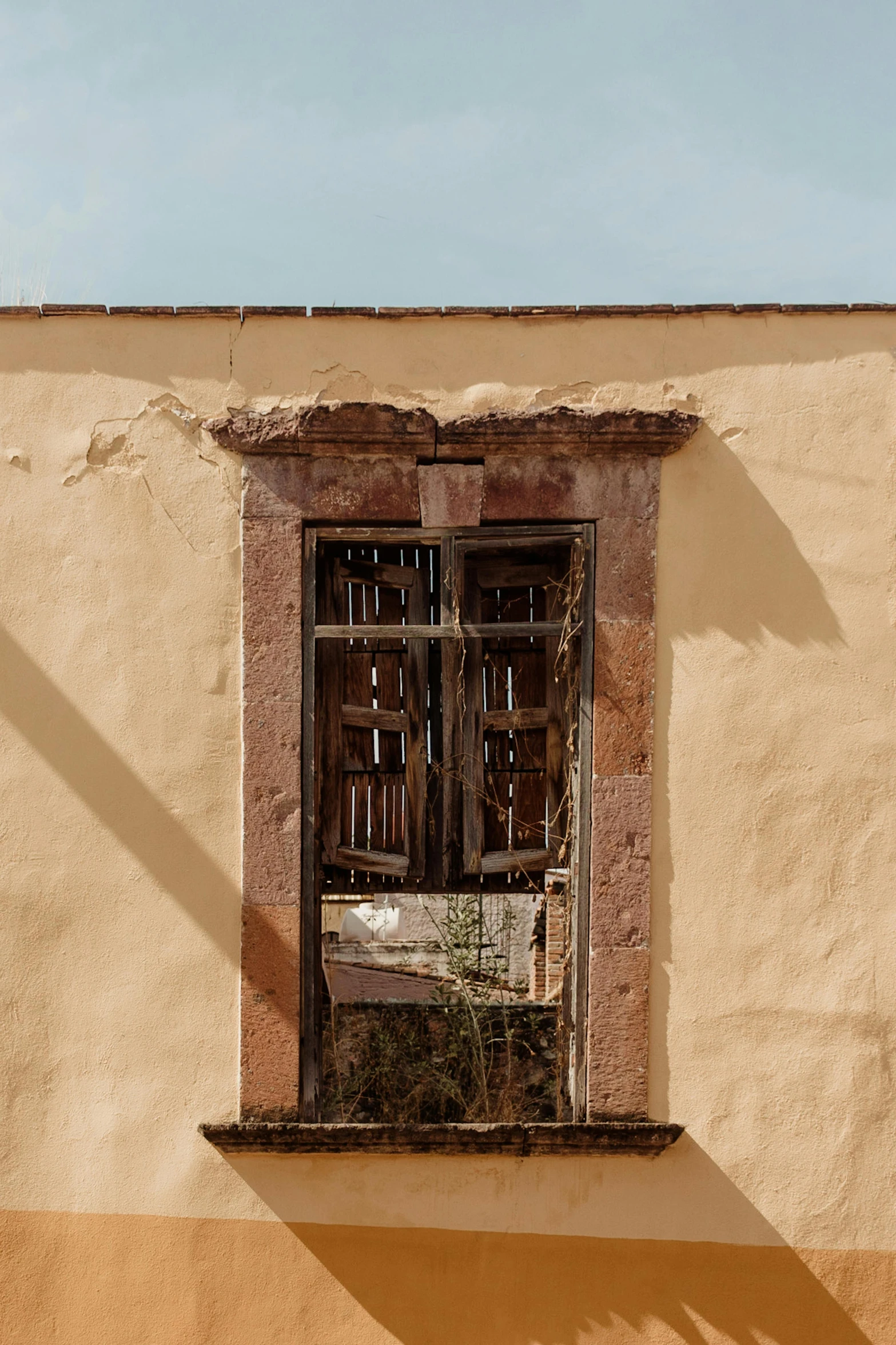 an open window with a small chair on a chair outside