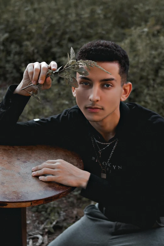 a boy holds a stick over his head