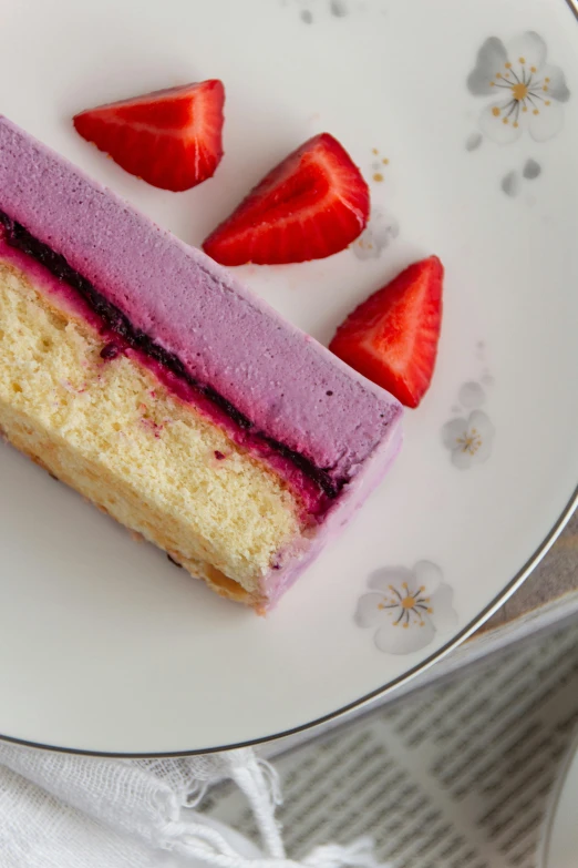 small slice of cake and some sliced strawberries on a plate