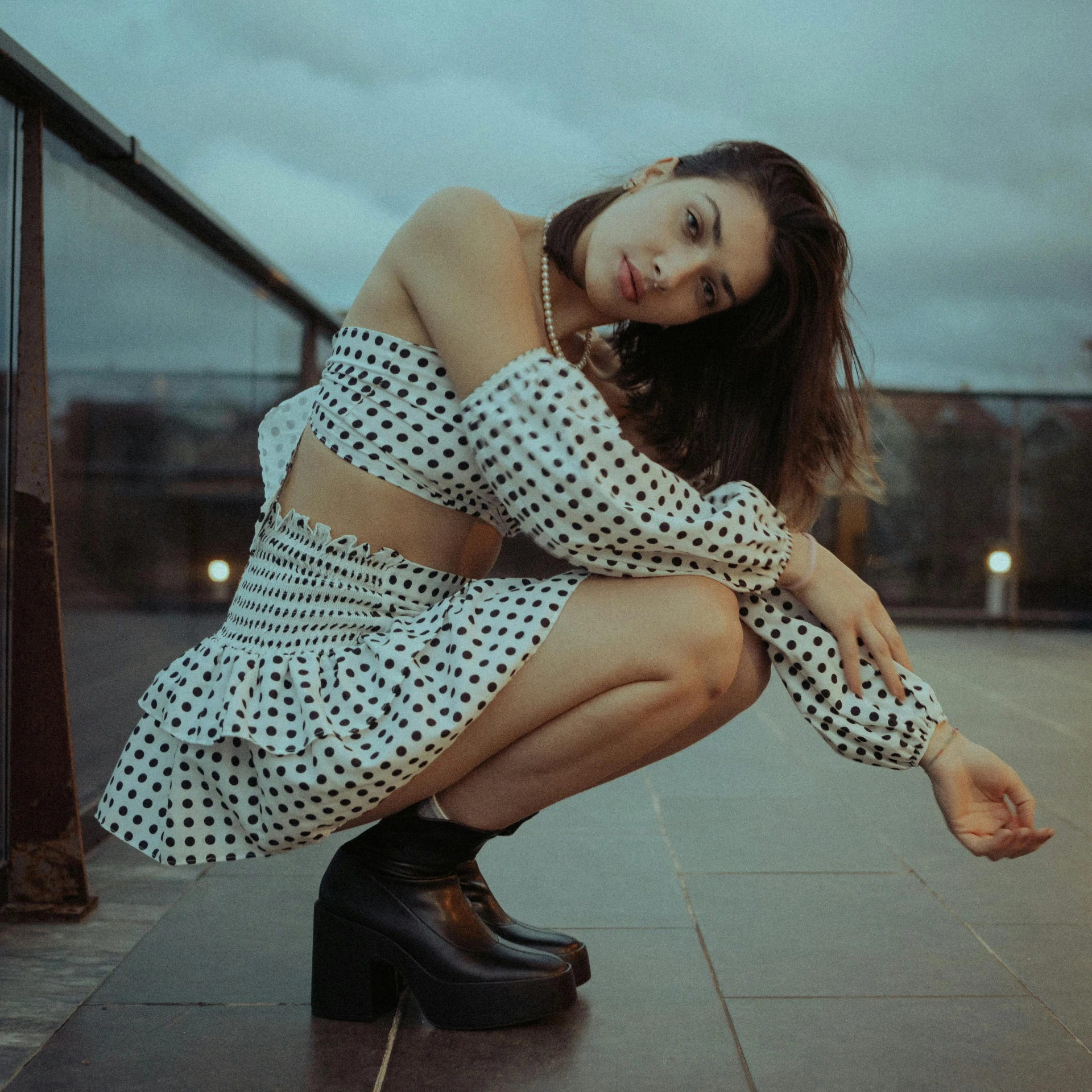 a woman is sitting on a ledge posing