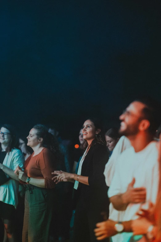 a group of people standing in a crowd near each other