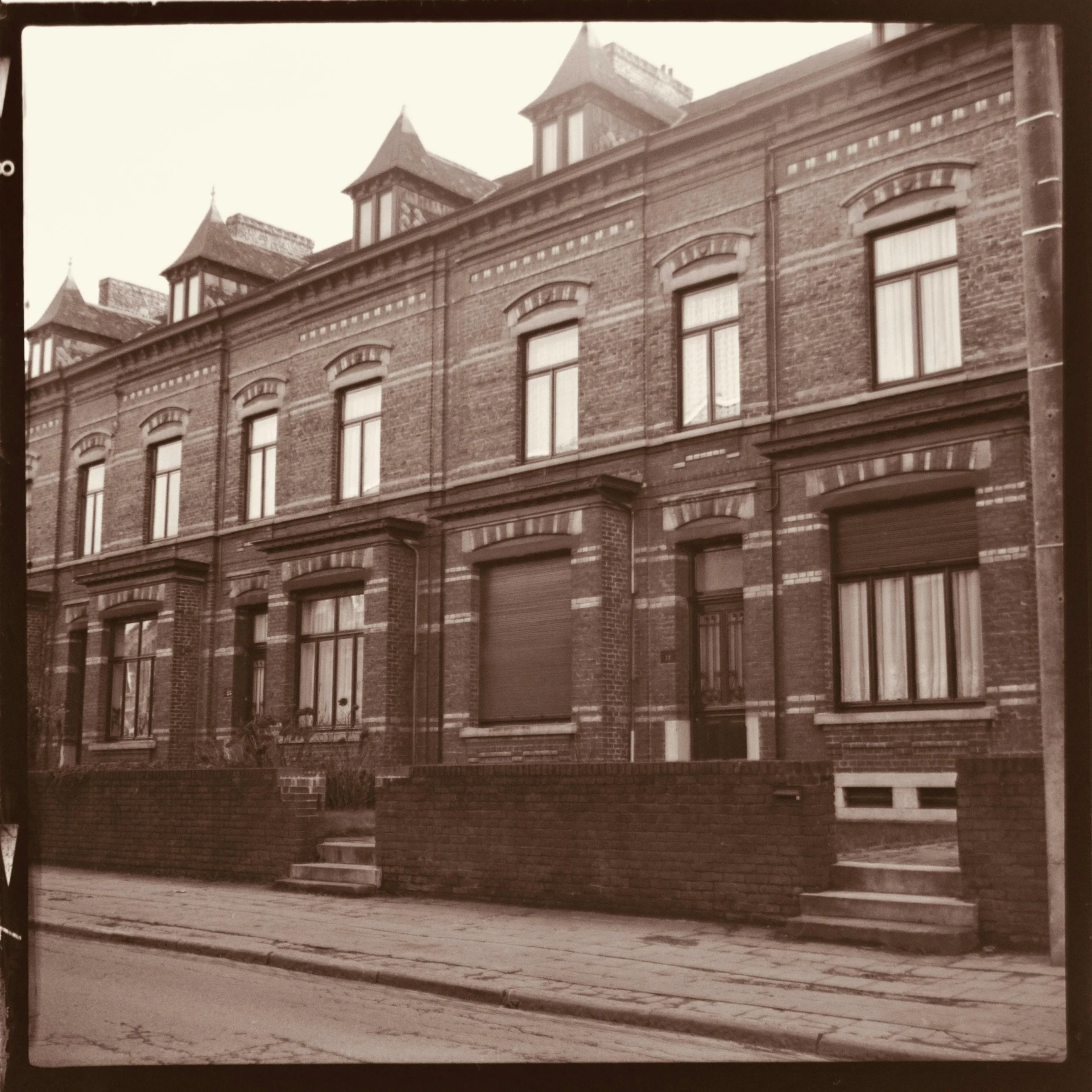 black and white pograph of two brick buildings