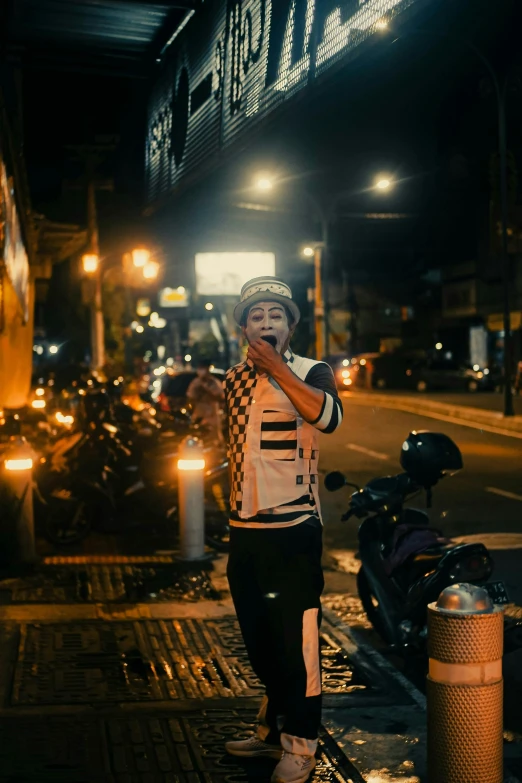 a person with his face painted standing next to a bunch of motorcycles