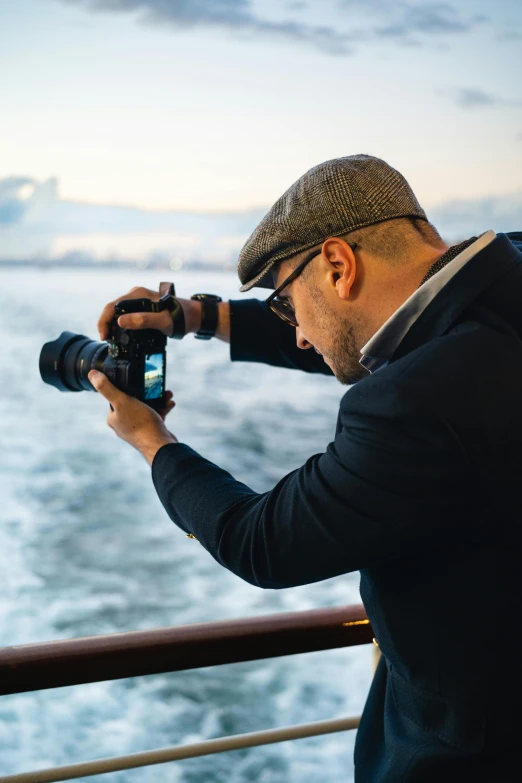 a man taking pictures on the deck of a ship