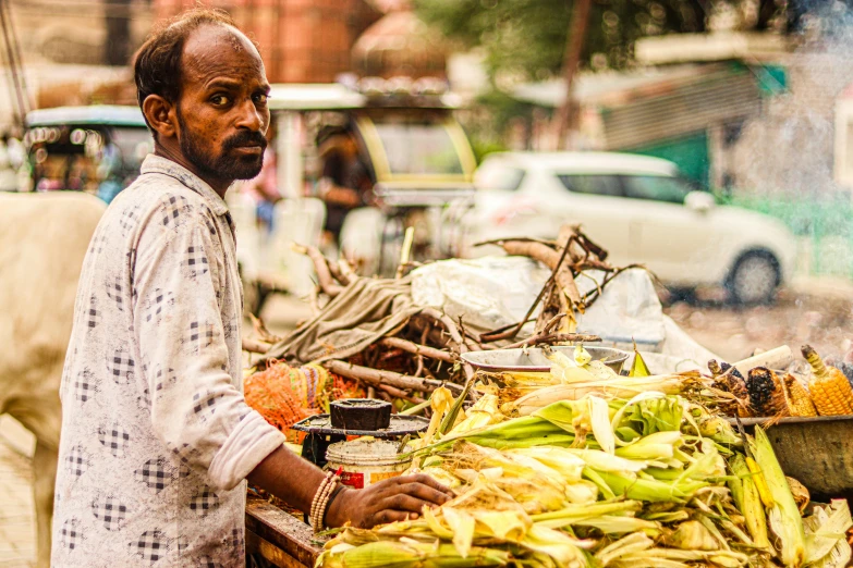 a man is selling bananas on the side of a road