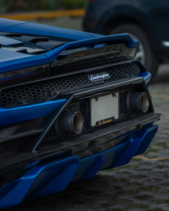 a blue sports car is parked on a street