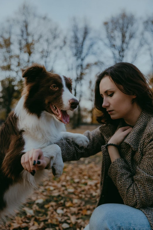 a woman with her dog in the middle of a field