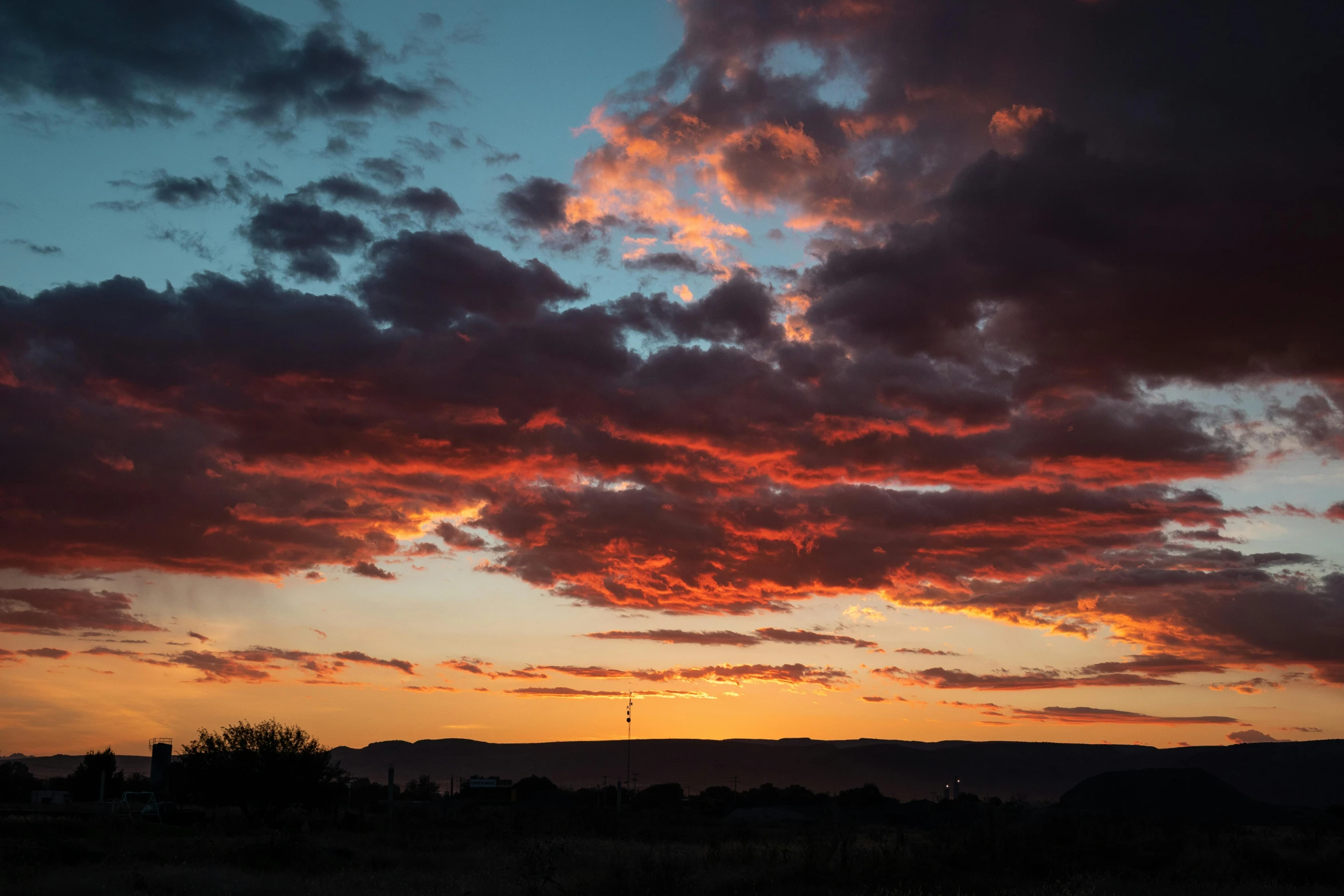 a sunset that is setting over the mountains