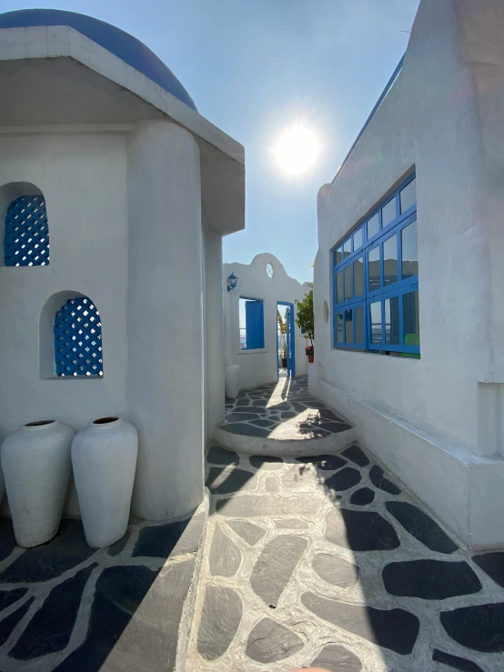 some white houses with large windows and small blue shutters