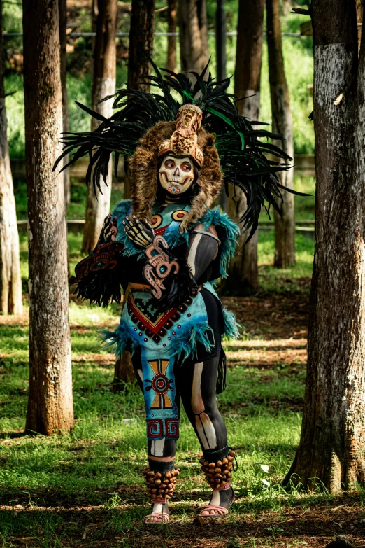 a man is wearing an elaborate dress in the forest