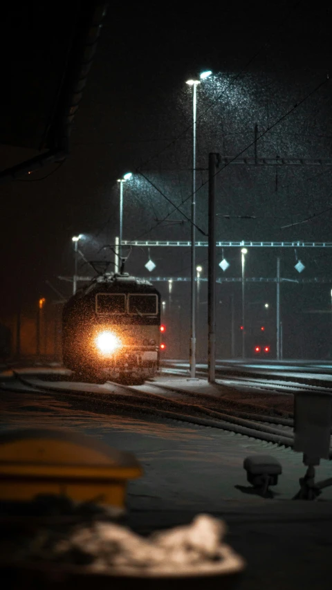 a train is going down the track at night