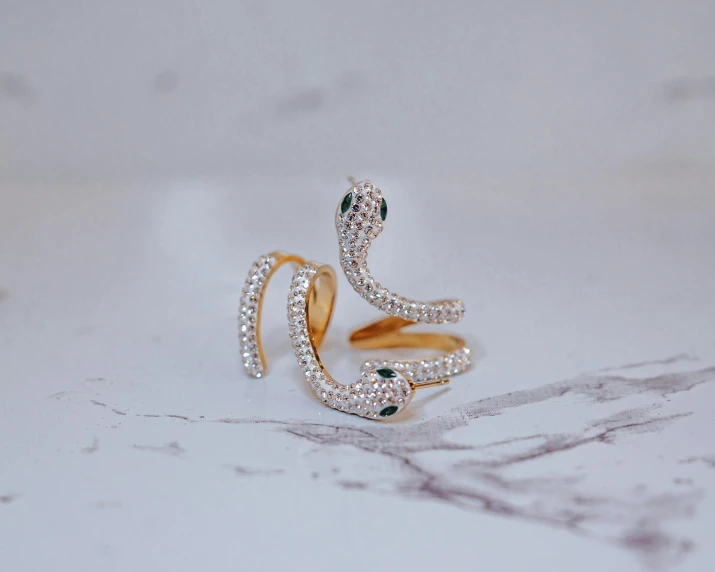 a couple of gold rings with diamonds and emeralds