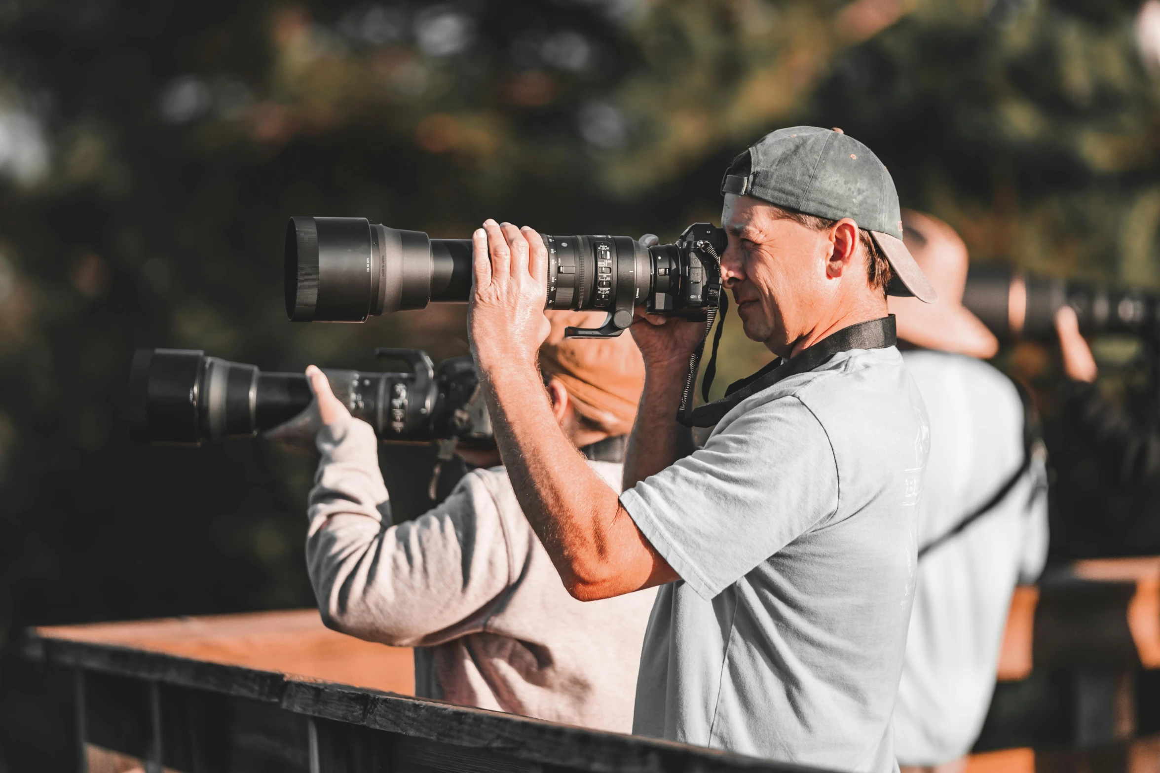 a man holding a camera over his shoulder