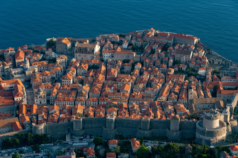 an aerial view of a city surrounded by sea