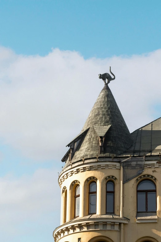 there is a tall building with a clock tower and a statue on top