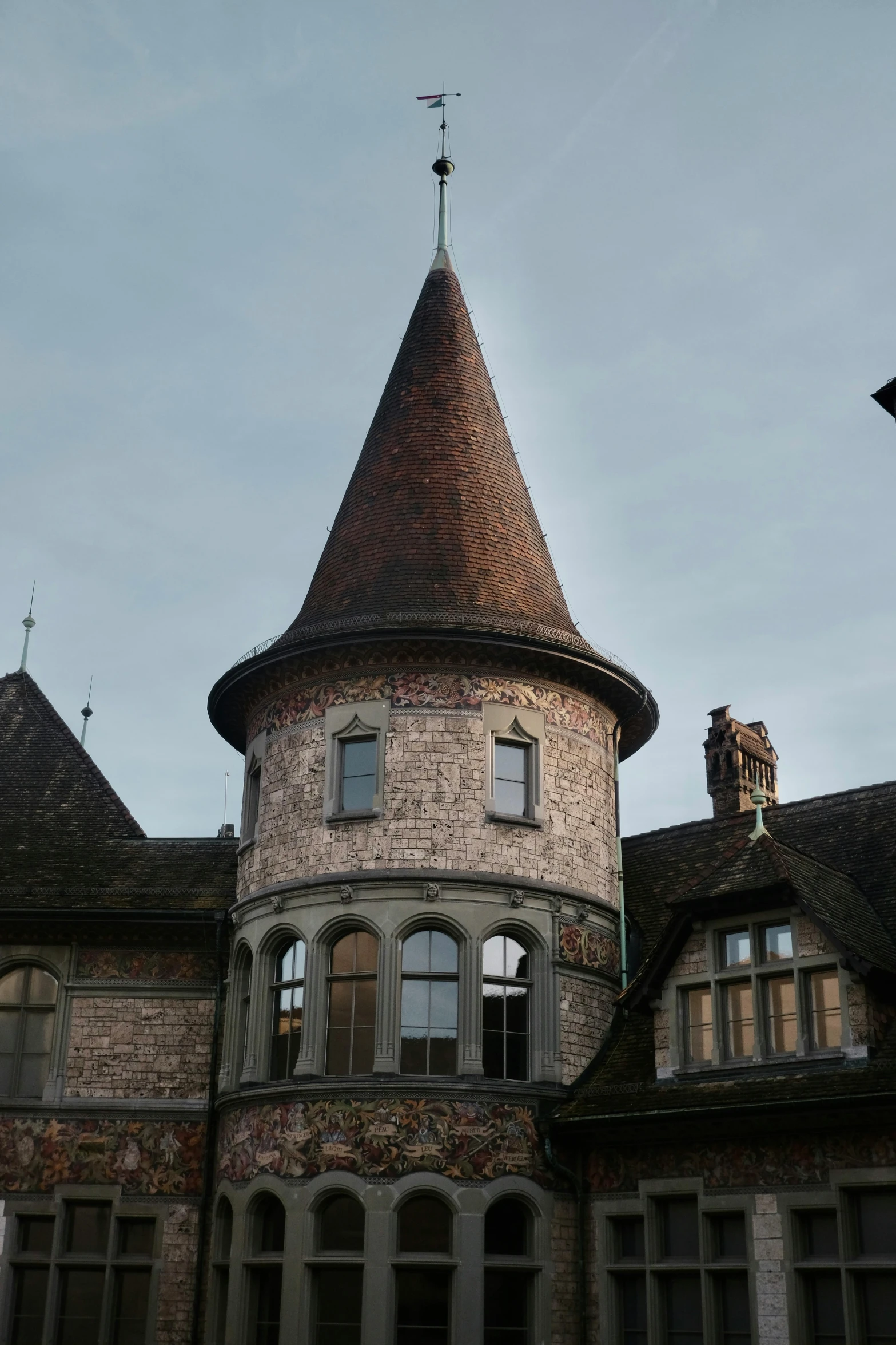 a tall tower with a pointed top on a cloudy day