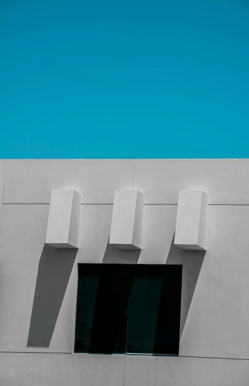 a blue sky is in the background as well as a window in a wall