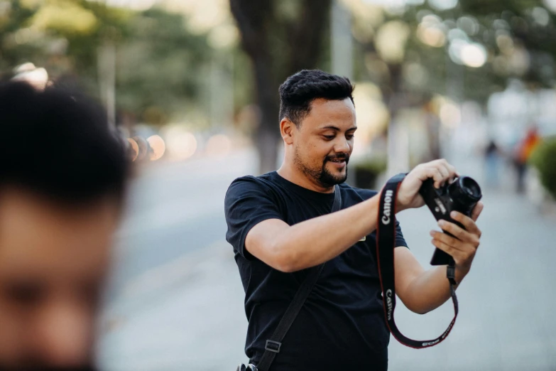 man taking picture with camera with blurred background