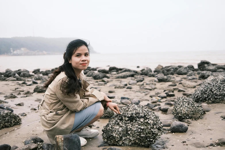 a beautiful woman sitting on top of a beach