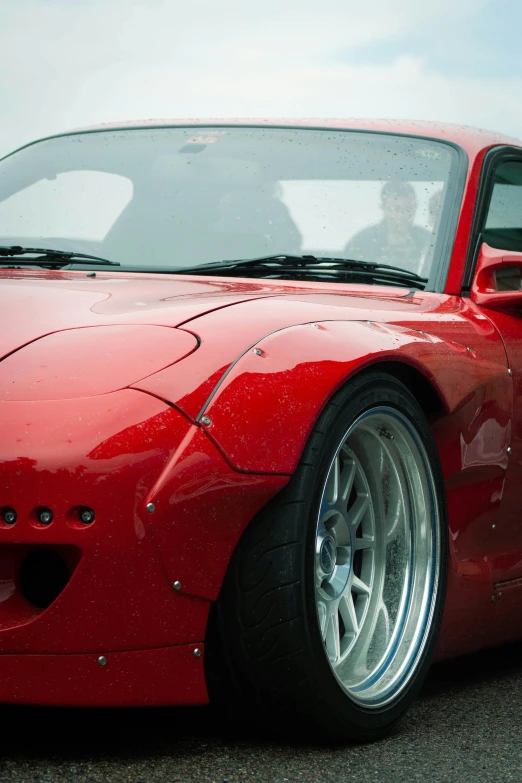 a close up of the front of a red sports car