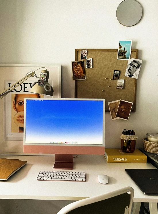 a desktop computer monitor sitting on top of a white desk