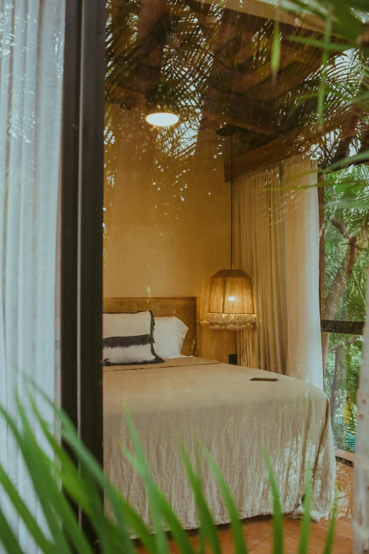 a bedroom with bed with canopy and lights on it