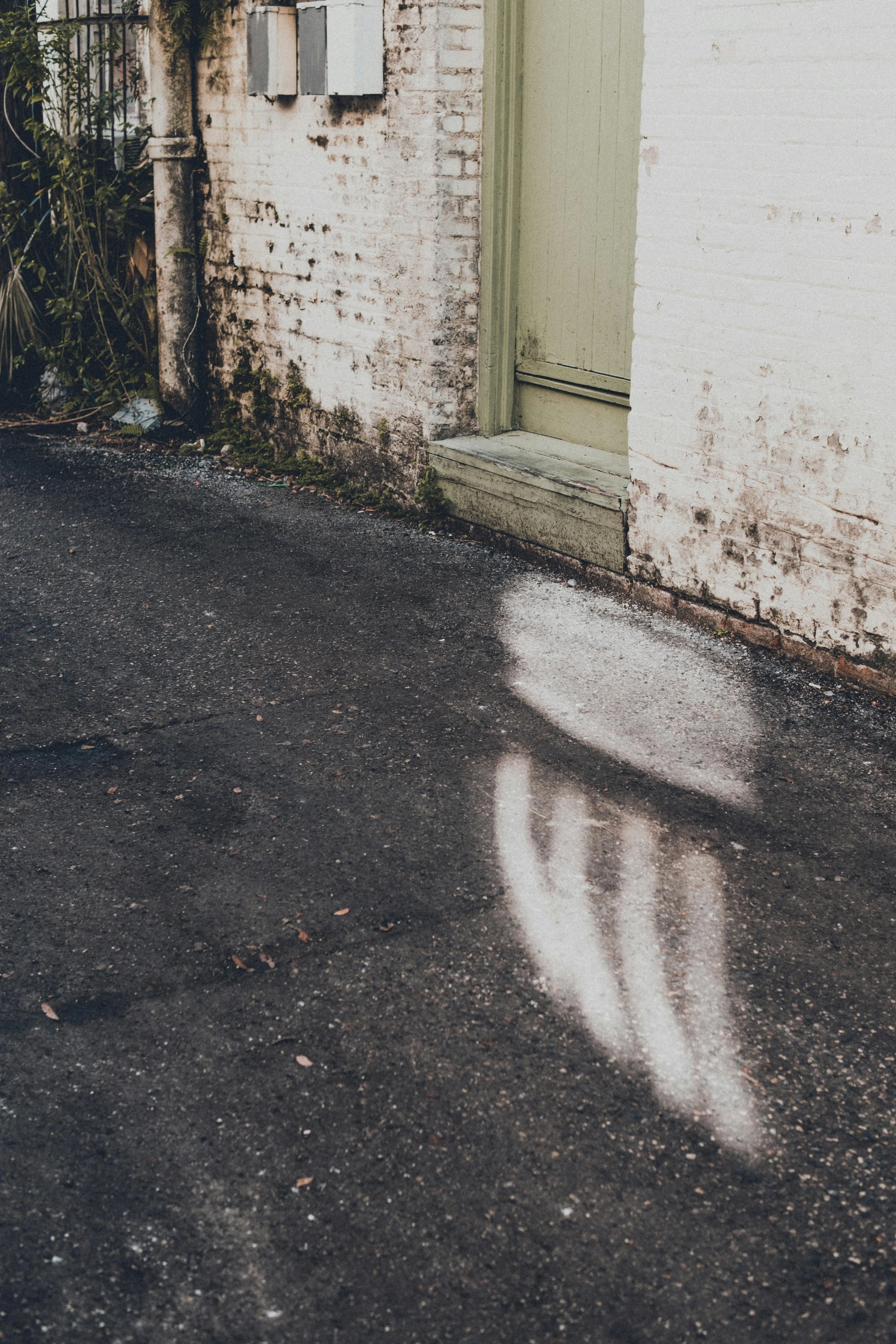 a shadow of a stop sign in the middle of an empty street