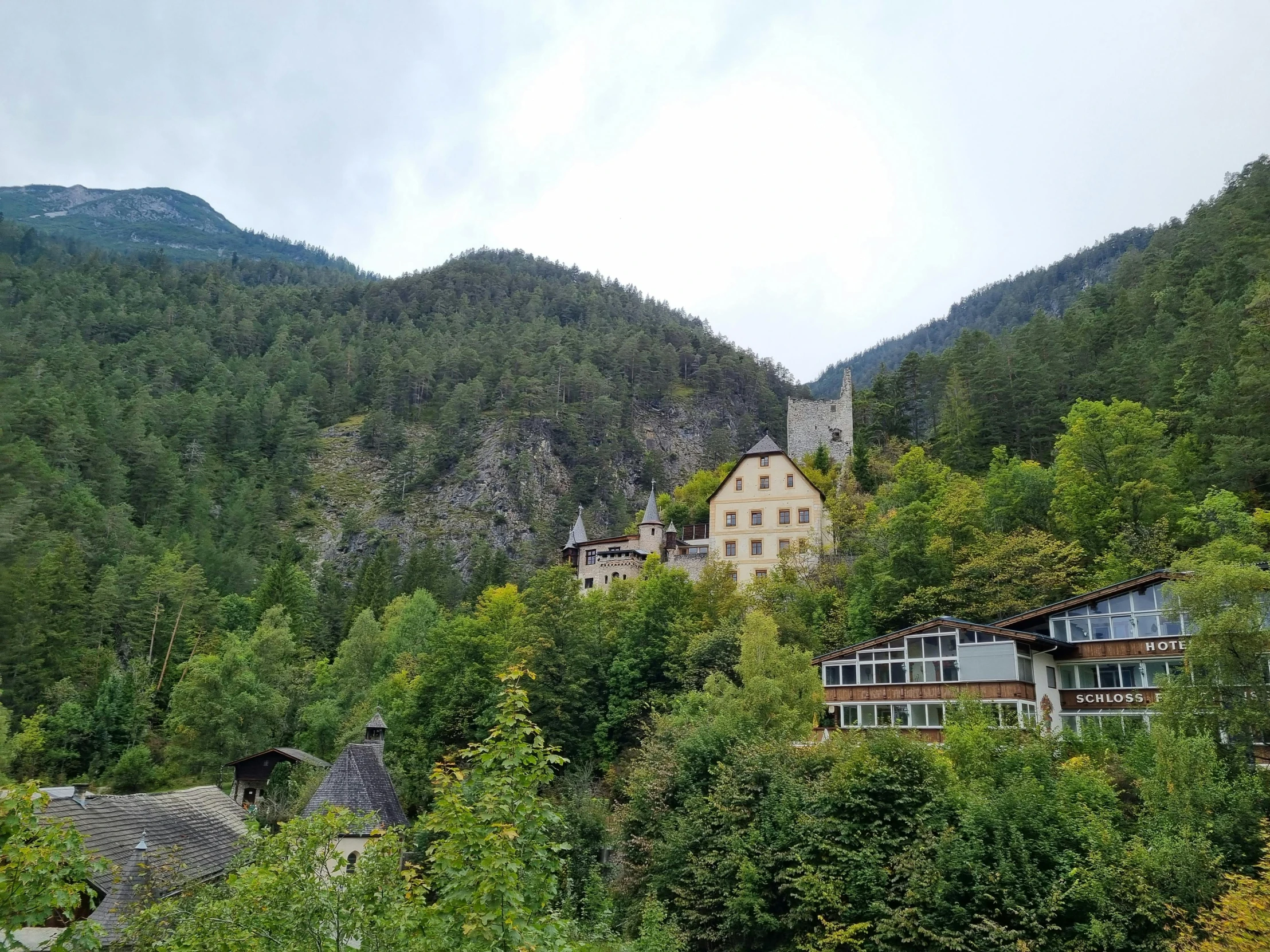 a mountain that is next to some green trees